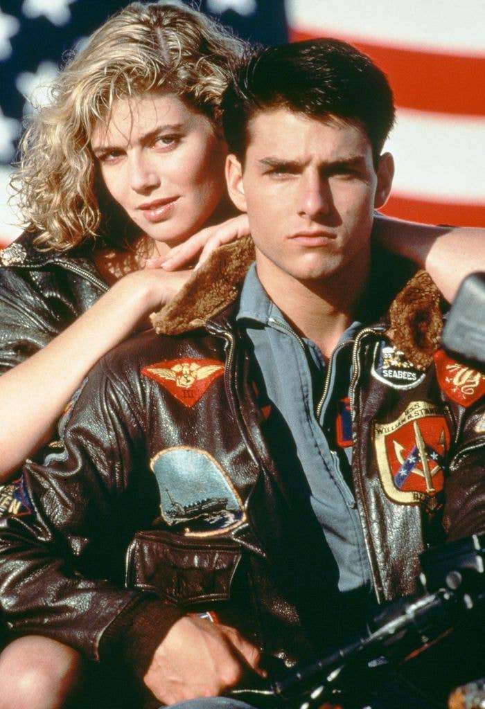 American actors Tom Cruise, as Lieutenant Pete 'Maverick' Mitchell, and Kelly McGillis, as Charlotte 'Charlie' Blackwood, in a promotional portrait for 'Top Gun'.