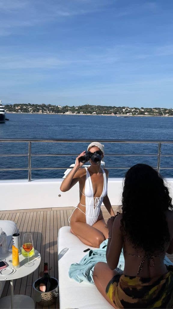photo of bella hadid in white plunging swimsuit on a yacht in cannes