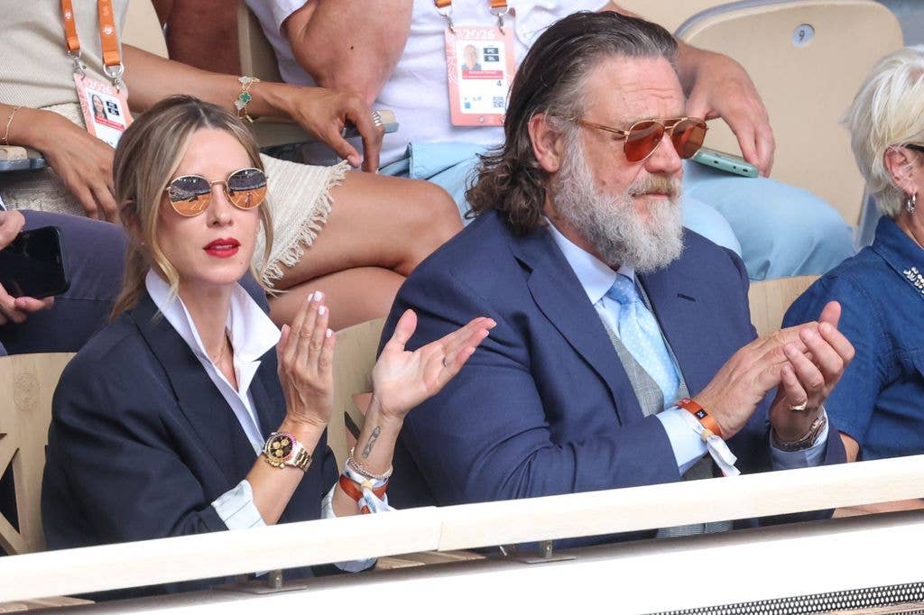 Britney Theriot and Russell Crowe in navy blazer attend Day One of the 2026 French Open