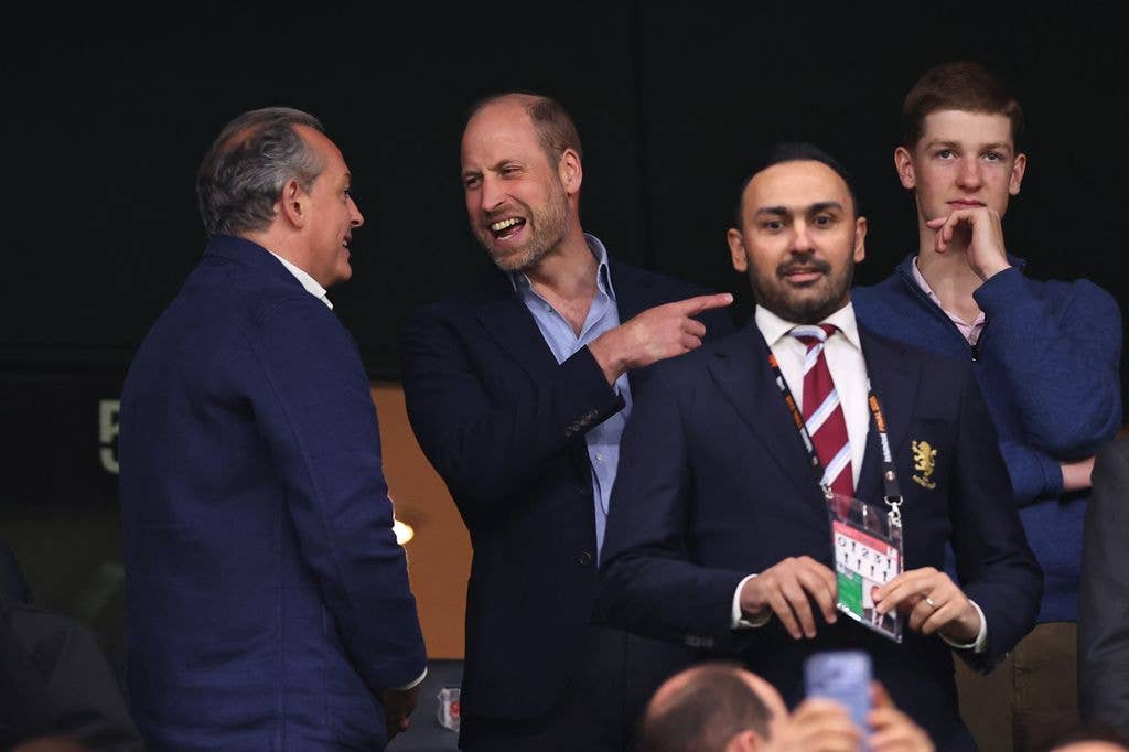 Prince William laughing and smiling with a man