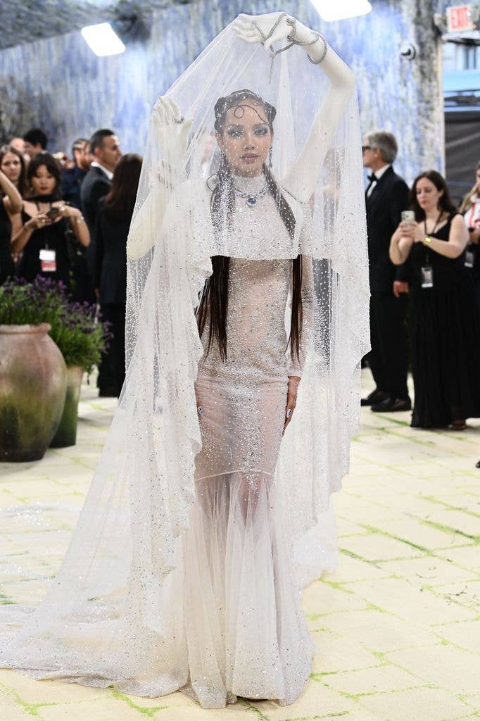 Lisa wore a sheer white dress and cascading head piece