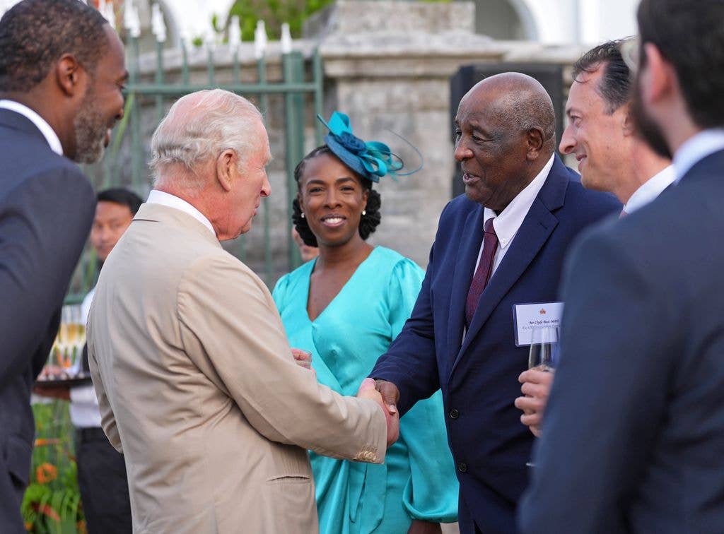 King Charles III speaks to Clyde Best (R) during a reception in the garden of Government House on May 1, 2026 in Hamilton, Bermuda. King Charles III is in Bermuda for his first visit to a British Overseas Territory as Sovereign.