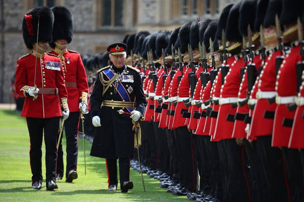 : King Charles III, Colonel in Chief of the Coldstream Guards, inspects the regiment during a ceremony to present new Colours to the 1st and 2nd Battalion (Number 7 Company) the Coldstream Guards at Windsor Castle on June 13, 2025 in Windsor