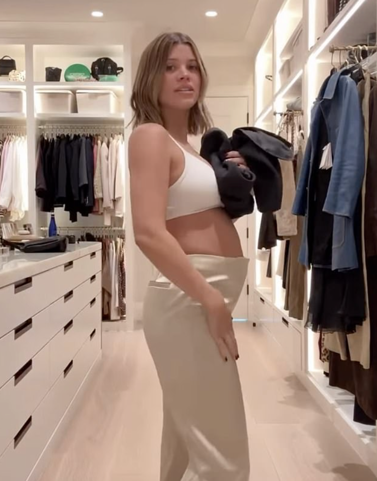 Wearing a simple white bra and casual trousers, Richie documented herself styling pieces from her label.