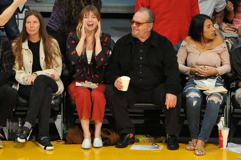 Lorraine Nicholson cheers as she sits next to her dad Jack Nicholson sitting courtside at a basketball game between the Los Angeles Lakers and the Golden State Warriors at the Staples Center
