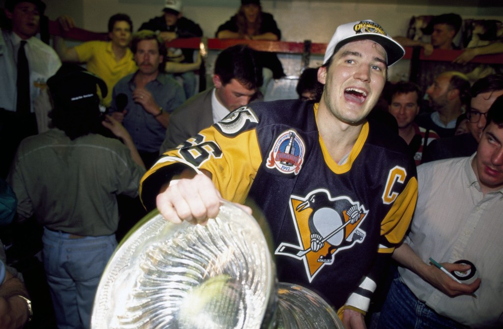 Hockey: NHL Finals: Pittsburgh Penguins Mario Lemieux (66) victorious in locker room with Stanley Cup trophy after winning game and series vs Chicago Blackhawks at Chicago Stadium. Game 6.Chicago, IL 6/1/1992
CREDIT: David E. Klutho (Photo by David E. Klutho /Sports Illustrated/Getty Images)
(Set Number: X43003 )