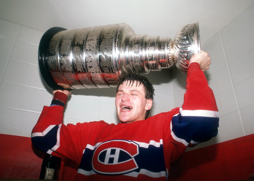 CALGARY, AB - MAY 24:  Claude Lemieux #32 of the Montreal Candiens celebrates with the Stanley Cup Trophy in the locker room after defeating the Calgary Flames in Game 5 of the 1986 Stanley Cup Finals on May 24, 1986 at the Olympic Saddledome in Calgary, Alberta, Canada.  (Photo by Bruce Bennett Studios via Getty Images Studios/Getty Images)