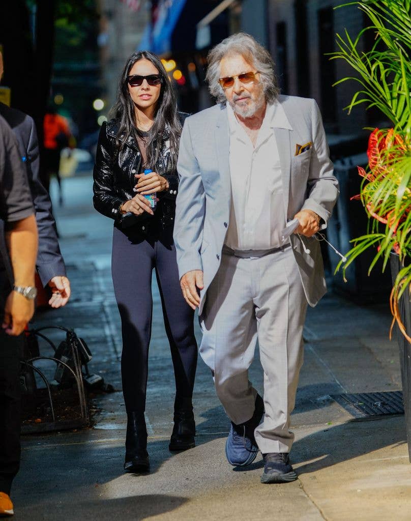 Noor Alfallah and Al Pacino walk down a street on their way to a music video shoot for Bad Bunny.