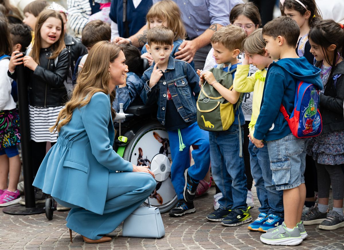 REGGIO EMILIA, ITALY - MAY 13: Catherine, Princess of Wales meets children as she visits the Piazza Camillo Prampolini where she is welcomed to the city at Reggio Emiliaâs Town Hall during the first day of her visit to Reggio Emilia on May 13, 2026 in Reggio Emilia, Italy. The Princess of Wales is visiting the city in Northern Italy as The Royal Foundation Centre for Early Childhood expands internationally. During her visit, she will explore leading approaches to early child development, which focusses on creativity, relationships and hands-on discovery. The trip marks the future queen's first overseas royal visit since her cancer treatment. (Photo by Samir Hussein/WireImage)