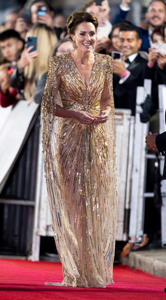 The gold gown features intricate sequin and beadwork designed to enhance the silhouette.