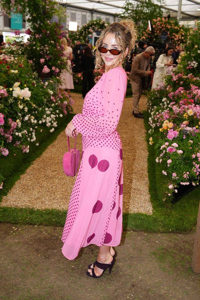 Lydia Bright wears a pink polka dot top and skirt