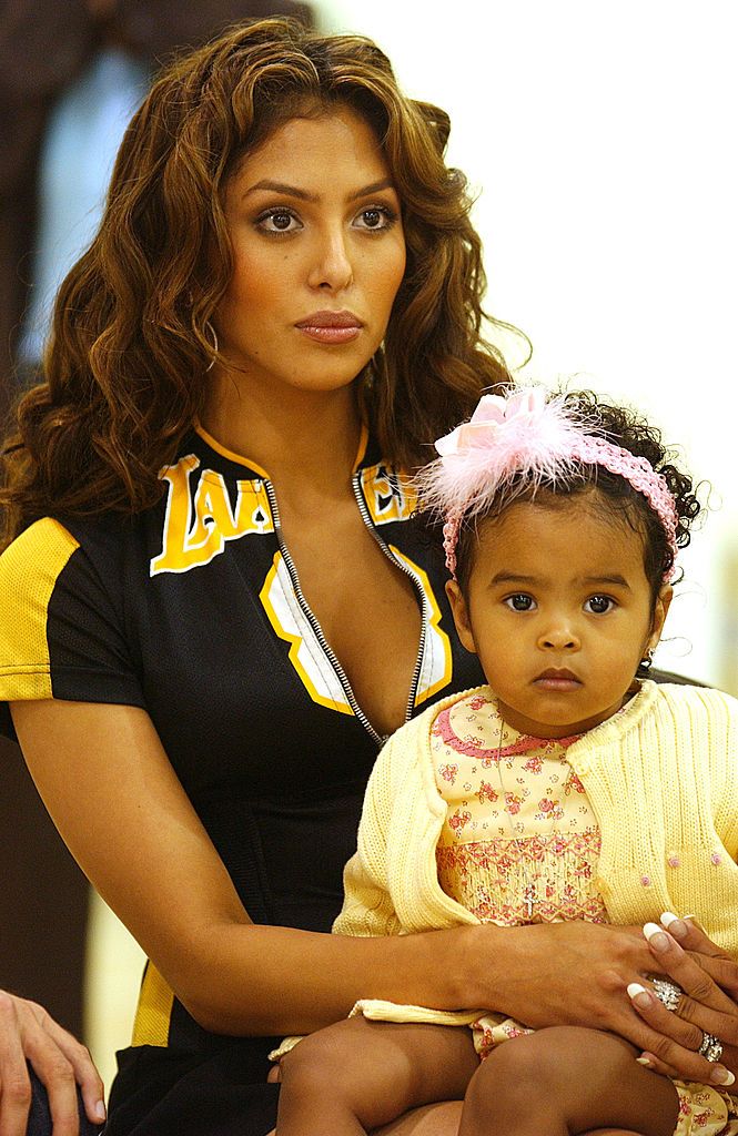 Vanessa and Natalia listen to Kobe speak at a press conference to announce he will remain with the Los Angeles Lakers in a seven-year deal for the NBA's league maximum of $136 million in El Segundo, California, July 15, 2004. 