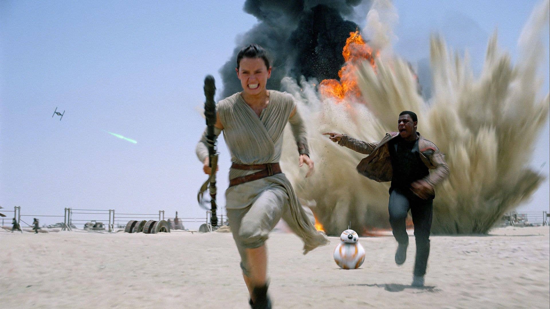 Still of Daisy Ridley and John Boyega running away from an explosion in Star Wars: The Force Awakens
