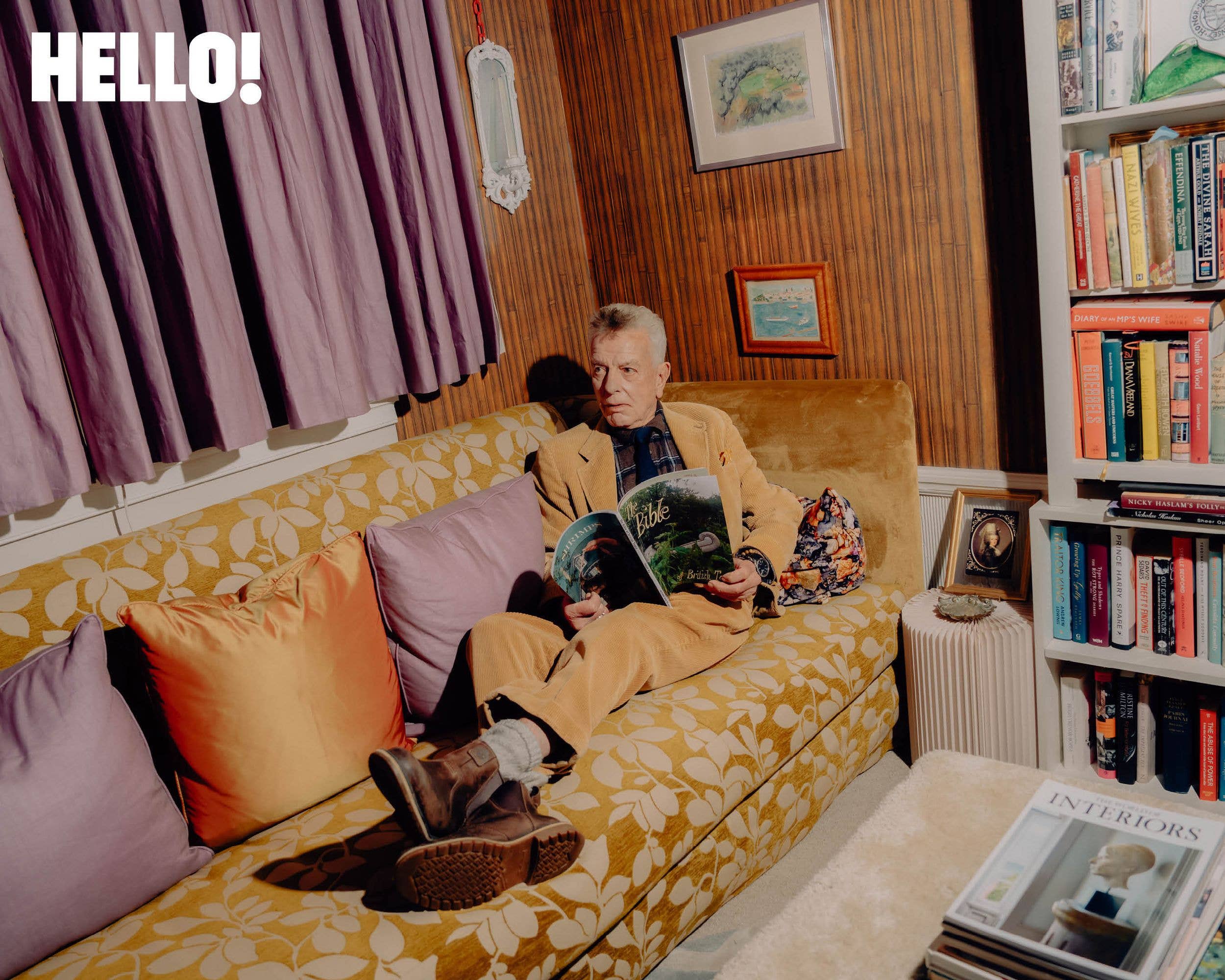 Nicky Haslam relaxes in his library