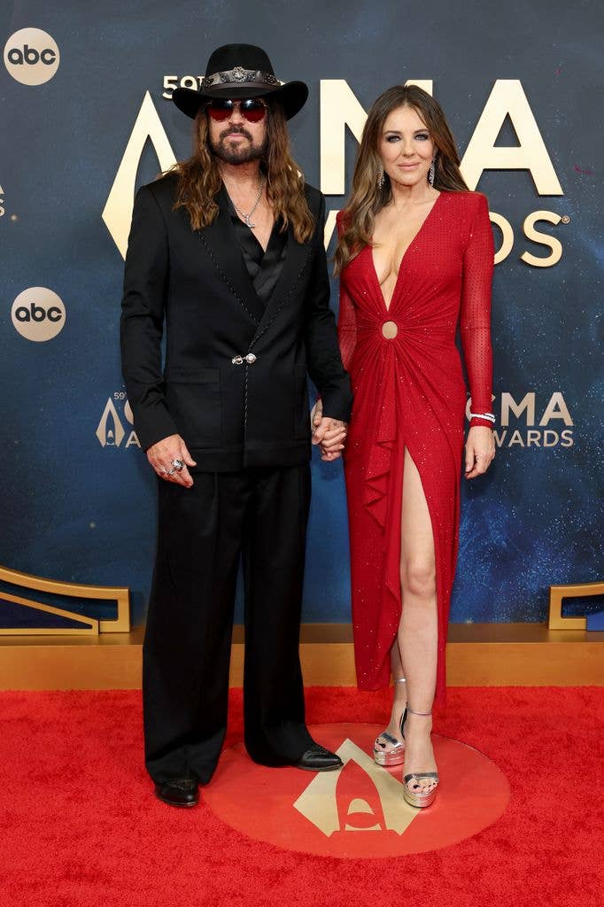photo of billy ray cyrus and elizabeth hurley holding hands 2025 cmas