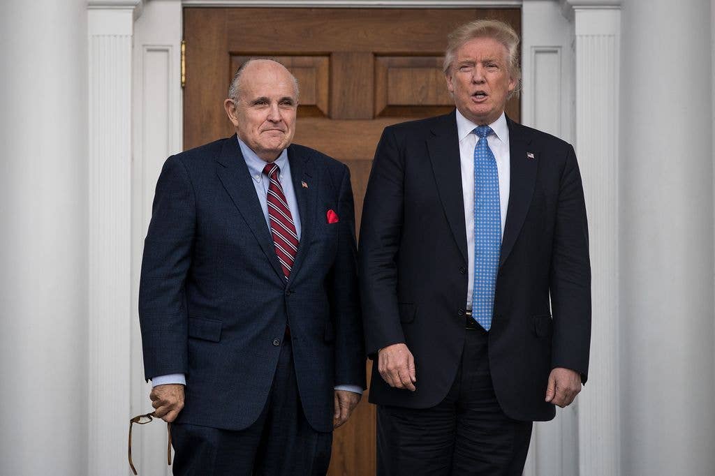 Former New York City mayor Rudy Giuliani stands with Donald Trump