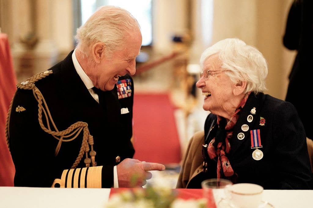 The King and a World War II veteran laughed together during a tea party at Buckingham Palace in 2025.
