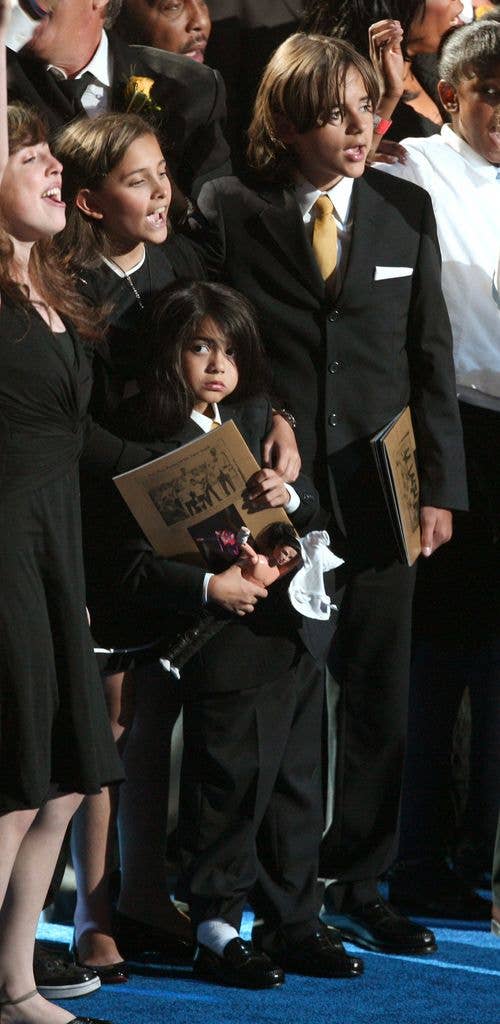 Michael Jackson's children (2L-R) Paris Jackson, Prince 'Blanket' Jackson II and Prince Michael Jackson stand on stage at the Michael Jackson public memorial service held at Staples Center on July 7, 2009