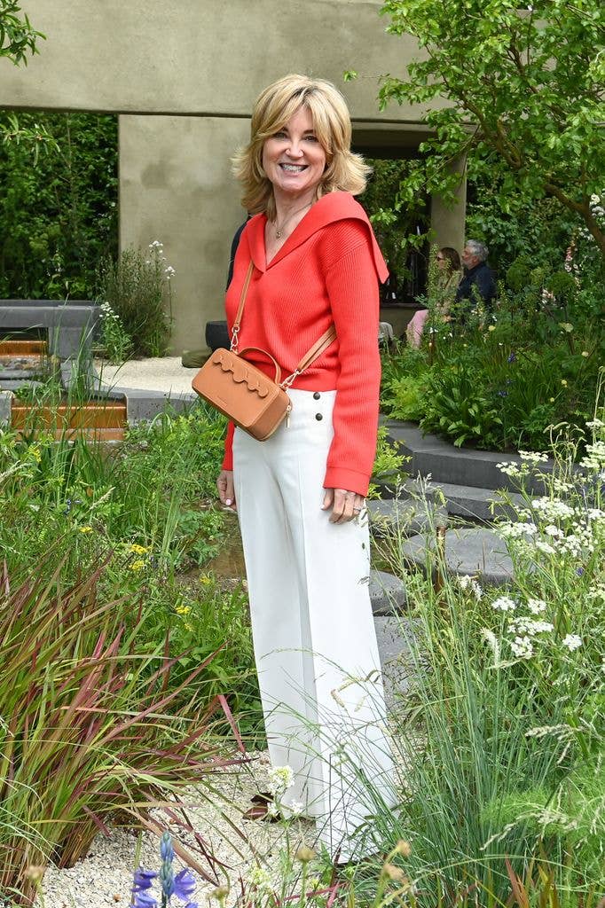 Anthea Turner wears a red top and white trousers