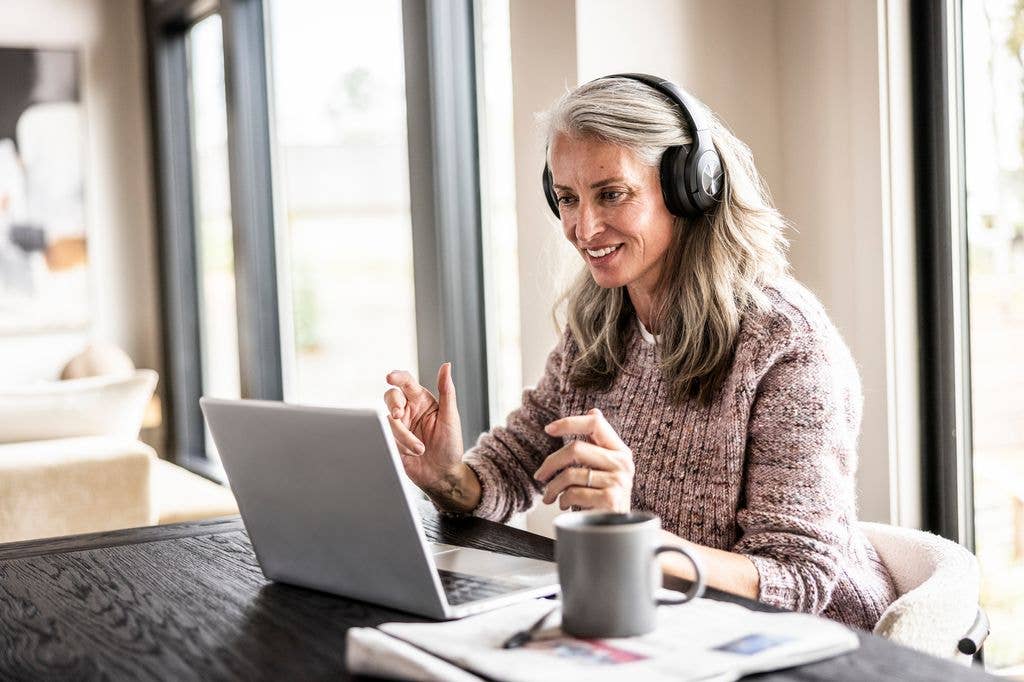 Senior woman using laptop for learning a new language