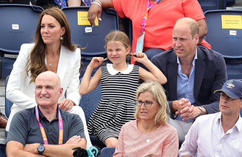Princess Charlotte pulling her pigtails next to Prince William