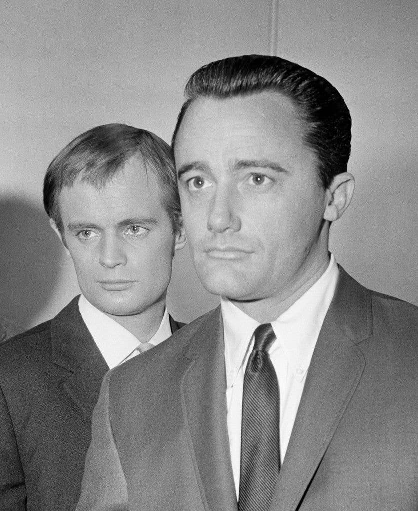 David McCallum, as Illya Kuryakin, stands behind Robert Vaughn's right shoulder, with Robert in character as Napoleon Solo in The Man from UNCLE.