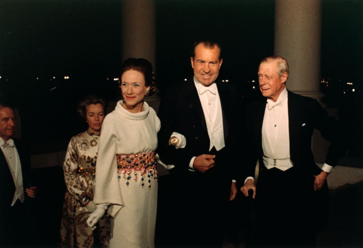 Richard Nixon escorts the Duchess of Windsor while the Duke stands nearby (at right). 