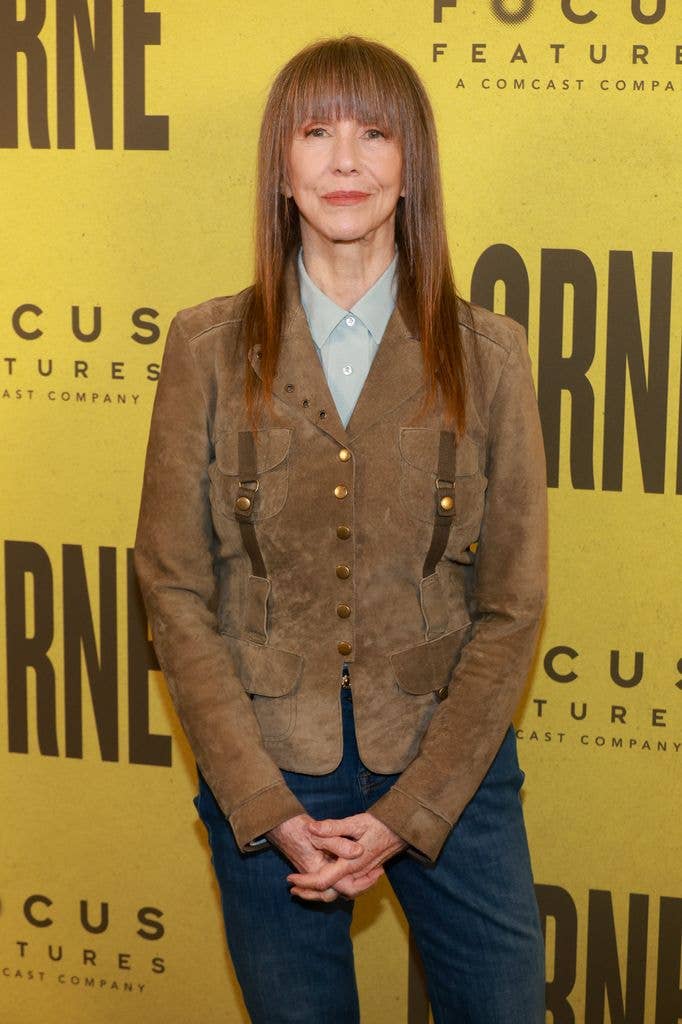 Laraine Newman in a brown suede jacket, blue grey shirt and jeans.