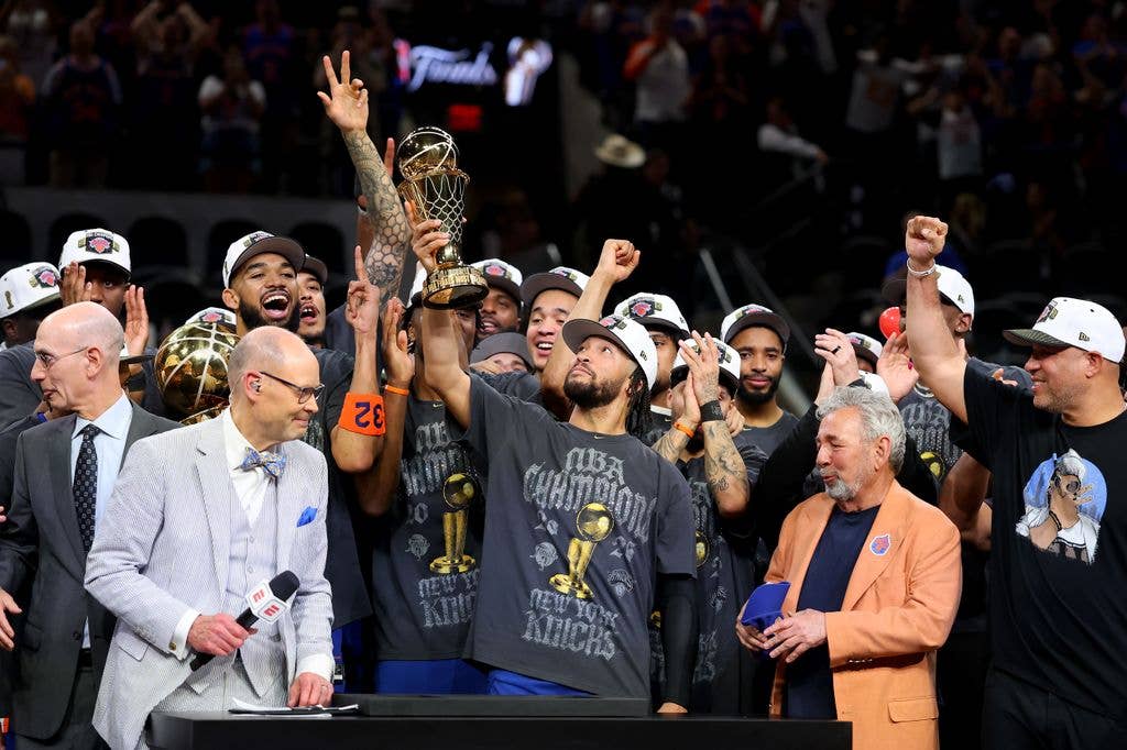 Jalen Brunson #11 of the New York Knicks lifts the Bill Russell NBA Finals Most Valuable Player Award trophy after defeating the San Antonio Spurs in Game Five of the 2026 NBA Finals at Frost Bank Center on June 13, 2026 in San Antonio, Texas.