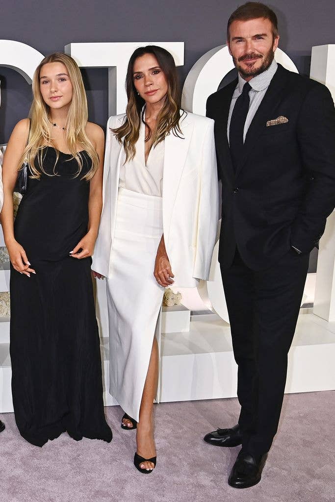 Harper Beckham in a black dress with Victoria Beckham in a white outfit