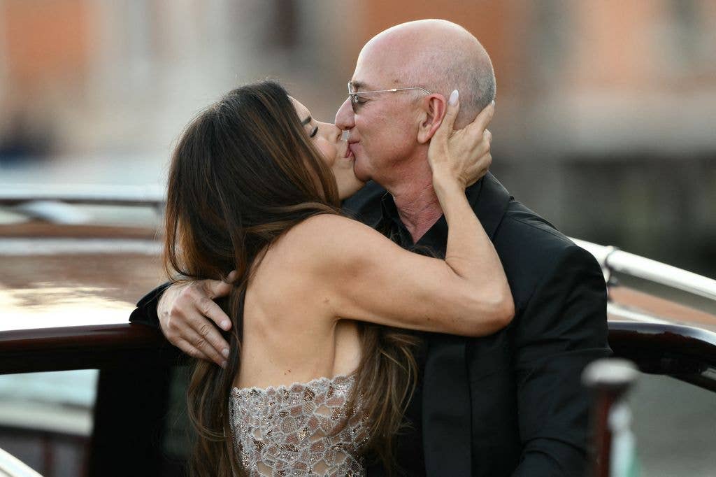 Amazon's founder Jeff Bezos and spouse Lauren Sanchez Bezos kiss as they leave the Aman Hotel on the third day of their wedding festivities, in Venice on June 28, 2025