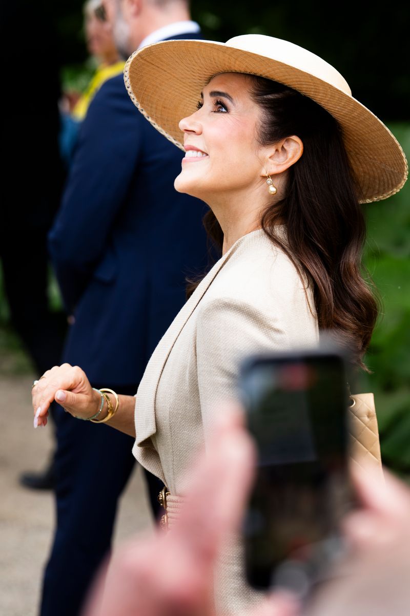 Soft waves, glowing skin, and understated makeup completed Queen Mary's polished daytime look.