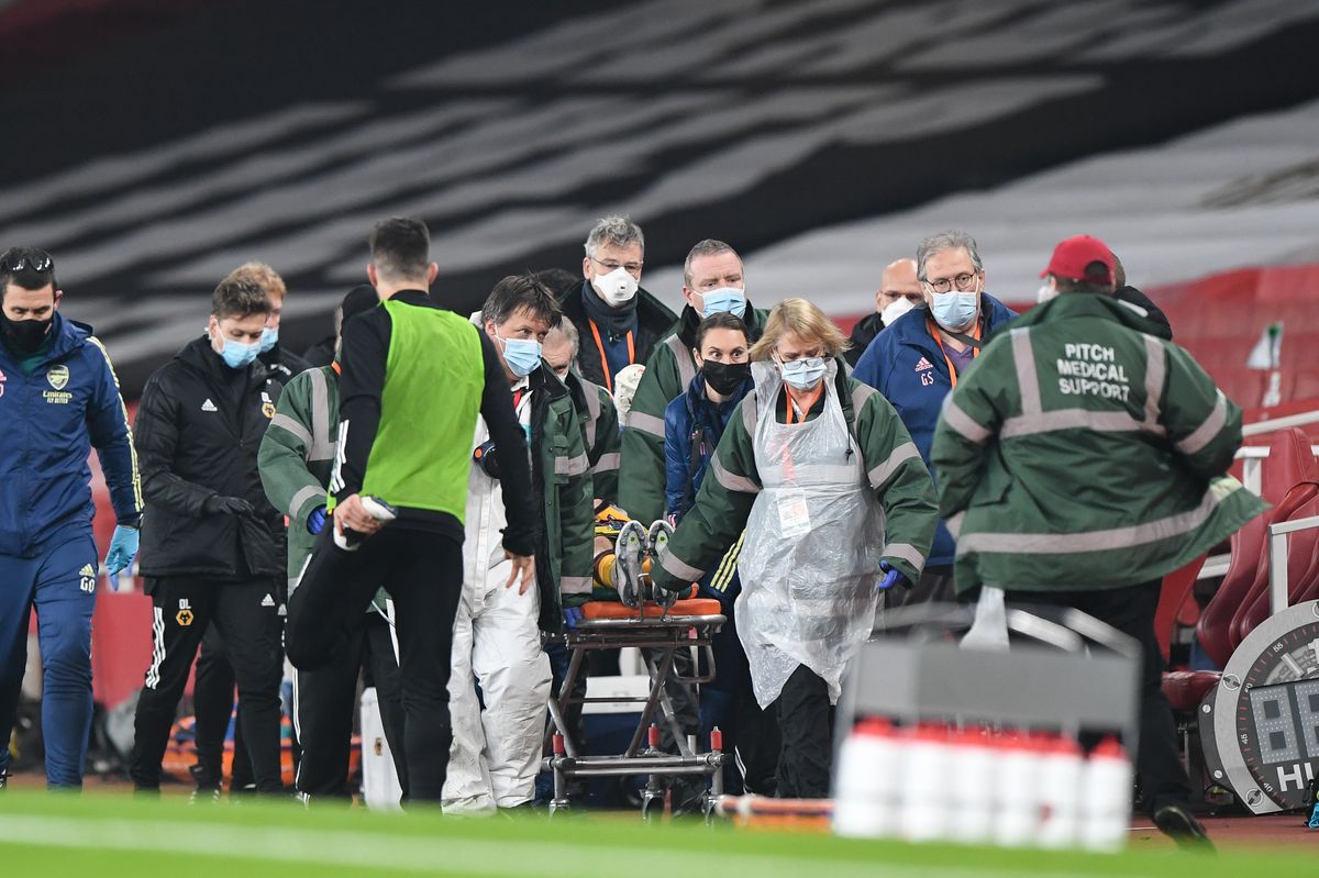 Raul Jimenez of Wolverhampton Wanderers is stretchered off the pitch by medics after a head injury during the Premier League match between Arsenal and Wolverhampton Wanderers. 