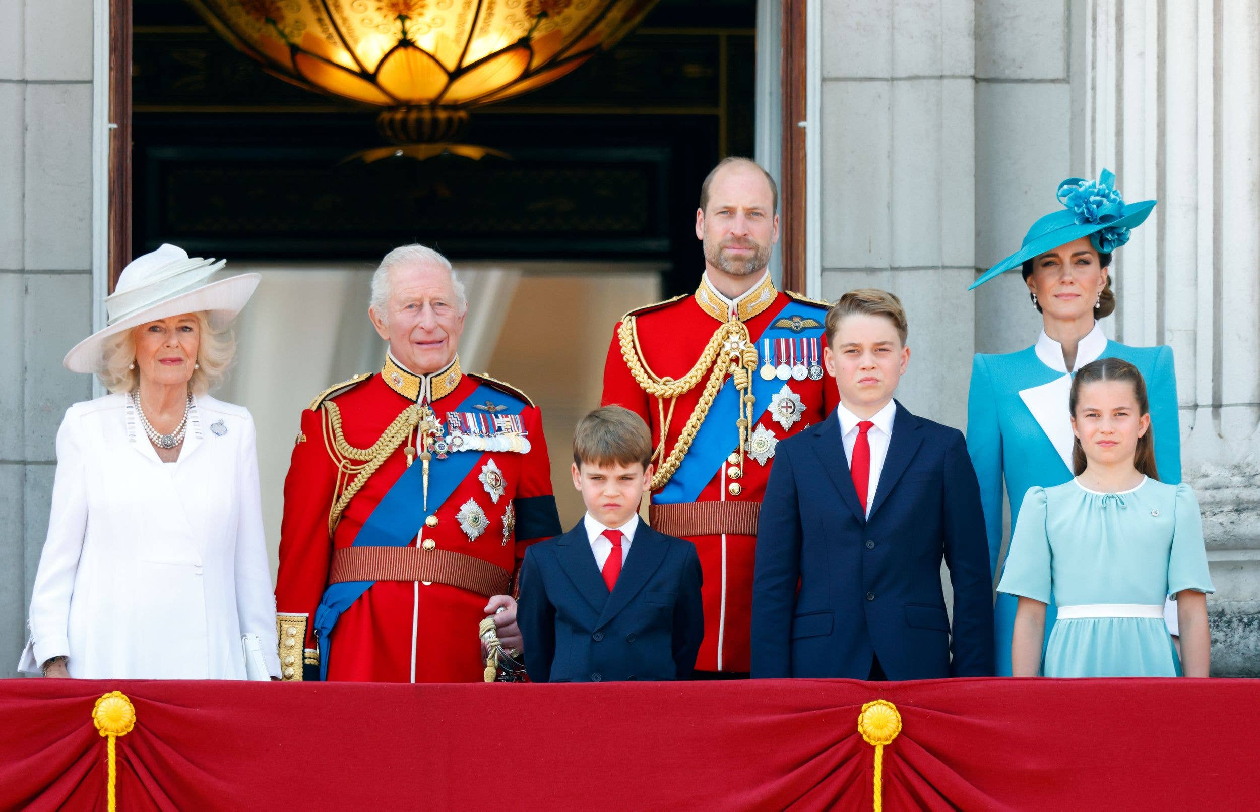 Prince Louis of Wales, Prince William, Prince of Wales (Colonel of the Welsh Guards), Prince George of Wales, Catherine, Princess of Wales and Princess Charlotte of Wales watch an RAF flypast from the balcony of Buckingham Palace 
