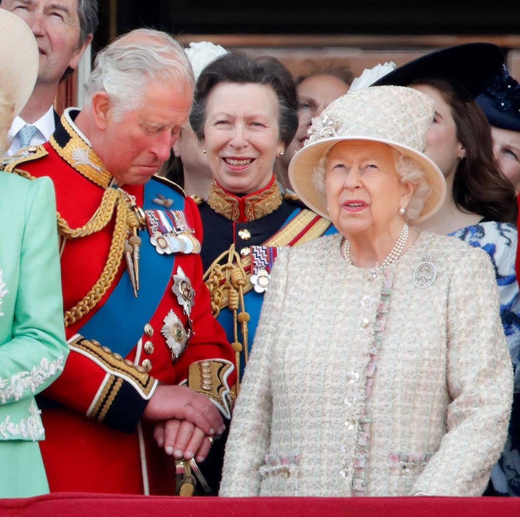 King Charles looking upset next to a grumpy Queen Elizabeth
