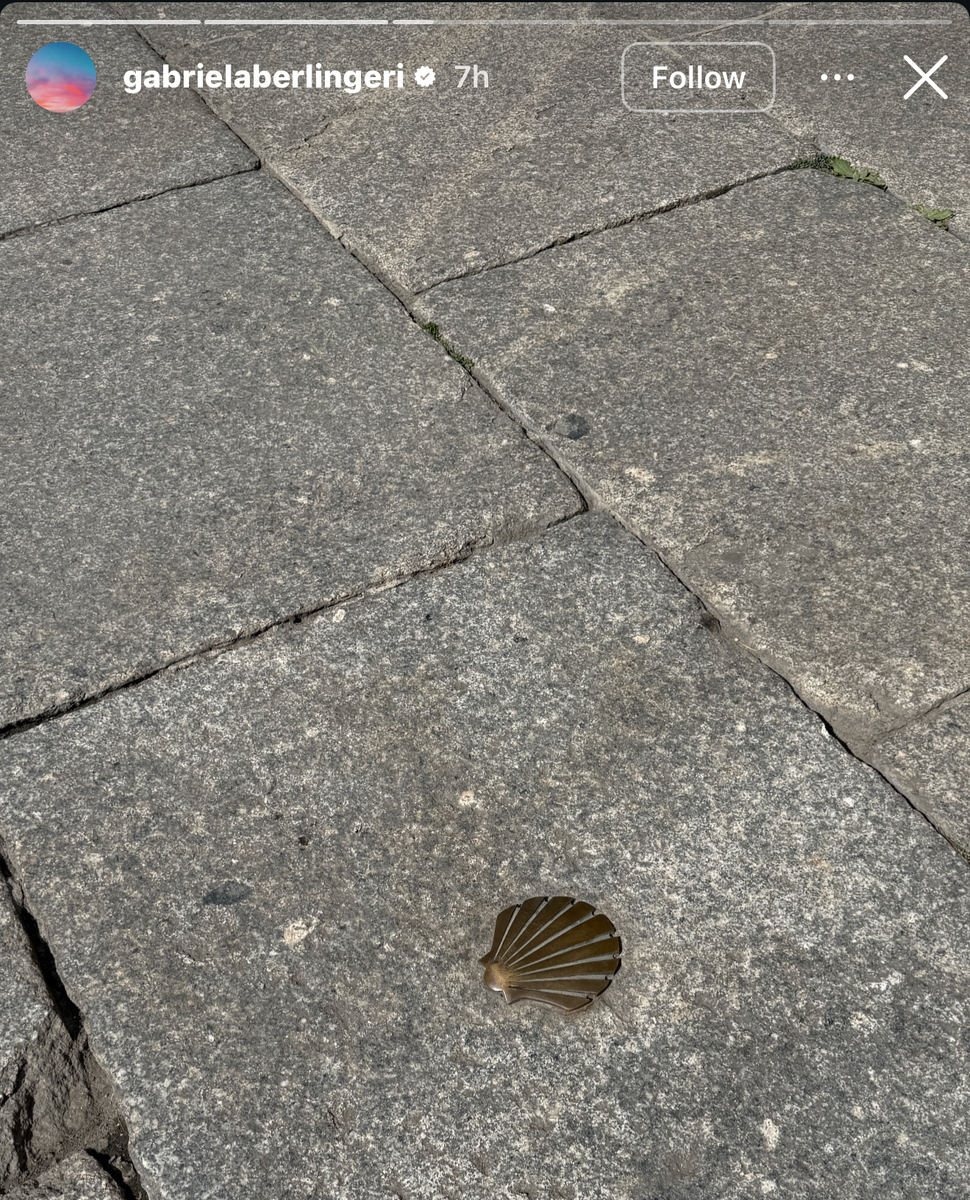 A bronze scallop shell embedded in the pavement — a symbol of the Camino de Santiago — appeared among the images shared on Gabriela Berlingeri's Instagram Stories.