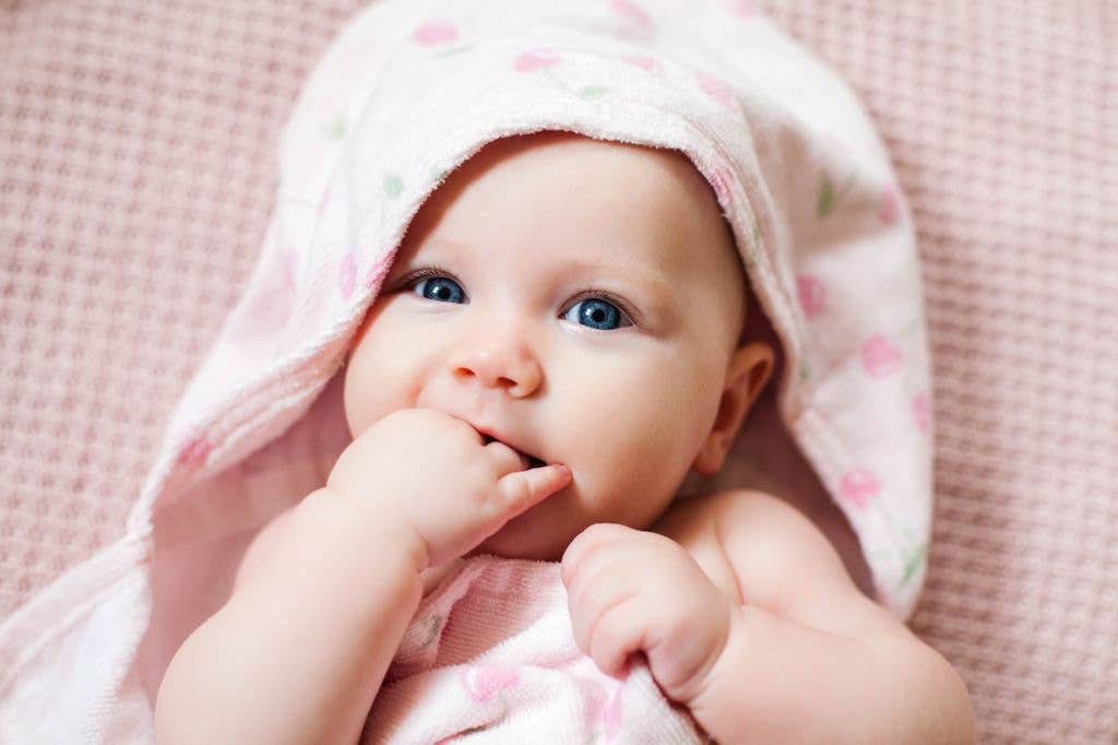 A baby girl wrapped in a towel