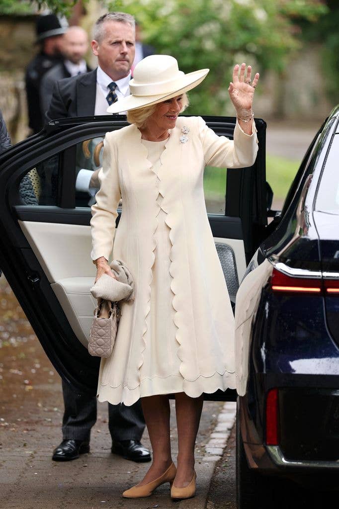 Queen Camilla waving as she gets out of the car