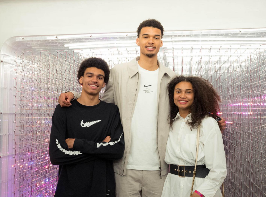 Photo shared by Victor Wembanyama's older sister Eve featuring the two with their younger sibling Oscar