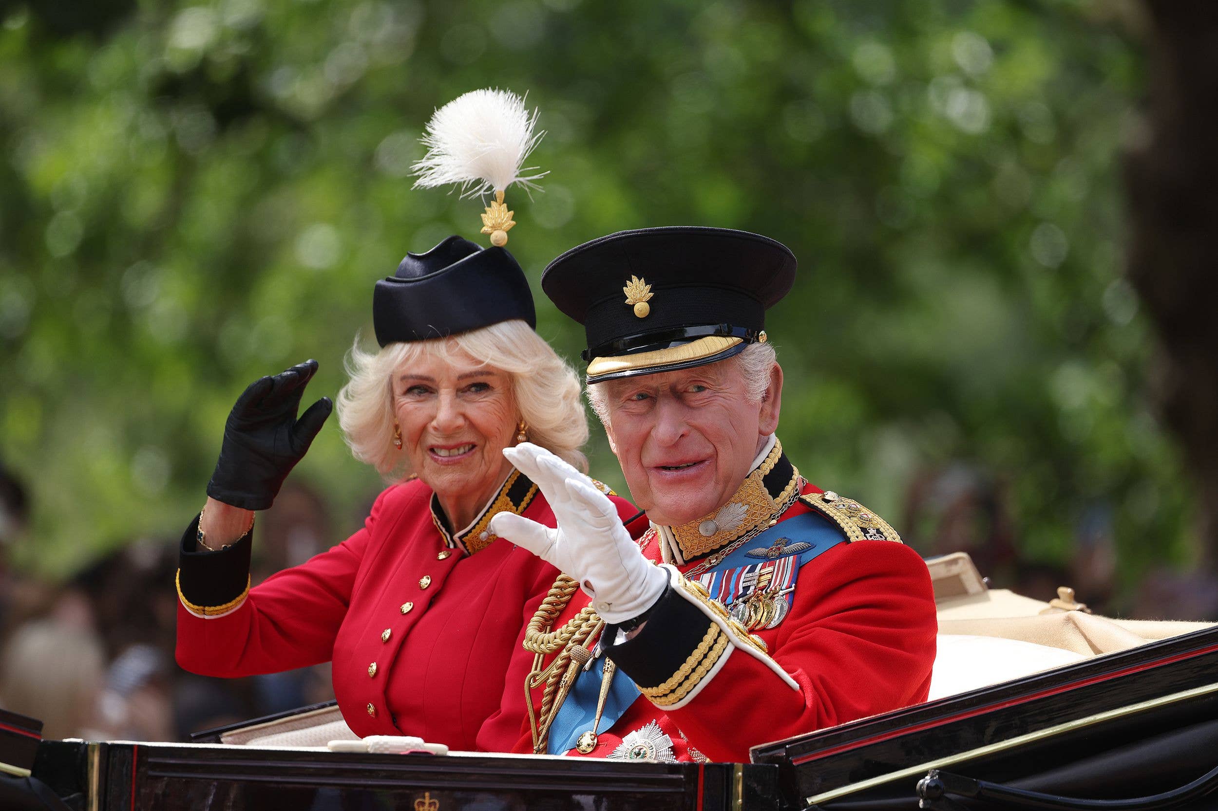 Enjoying the sunshine, the King and Queen wave to the crowds from their Ascot Landau