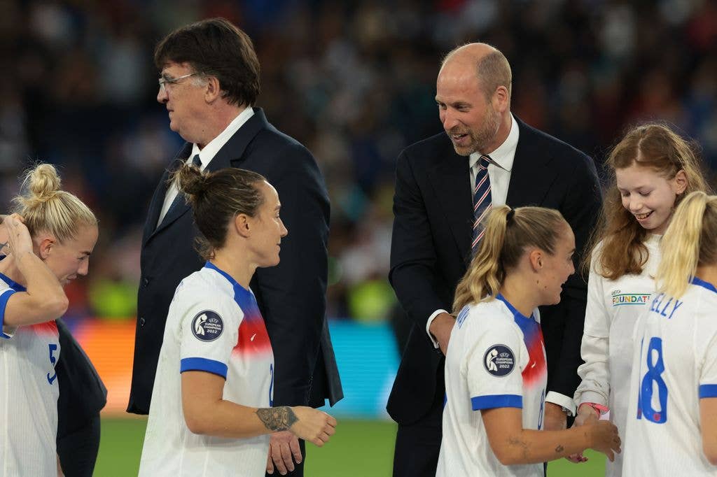HRH Prince William of Wales reacts with Lucy Bronze of England as Georgia Stanway of England shakes hands with a young girl by the name of Greta from Plus Sport Basel representing the UEFA Foundation for Children following the UEFA Women's EURO 2025 Final match between England and Spain at St. Jakob-Park on July 27, 2025 in Basel, Switzerland