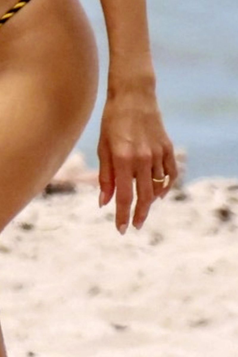 A dazzling diamond ring on Alessandra Ambrosio's left hand reignited engagement rumors with boyfriend Buck Palmer.