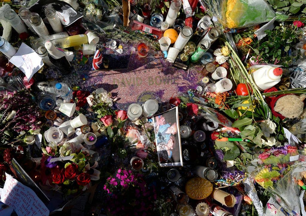 Candles, flowers and personal notes are placed as a memorial to musician David Bowie on his Hollywood Walk of Fame star on January 12, 2016.