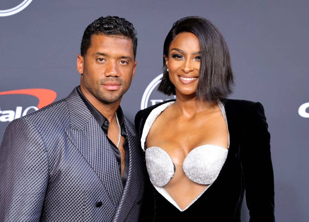 Ciara and Russell smiling at a red carpet event