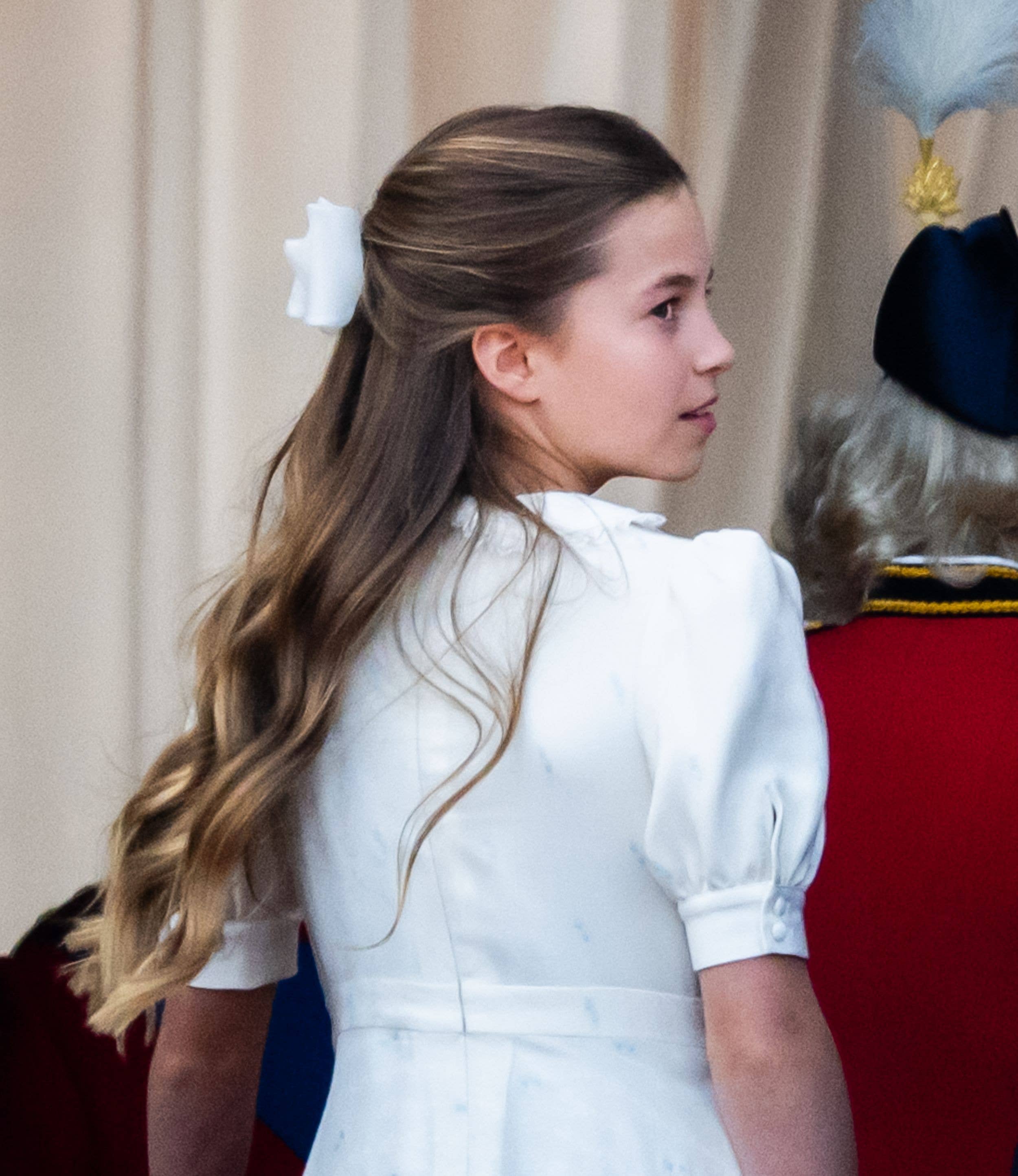 Charlotte wore a white cuffed dress by Alessandra Rich with a matching bow in her hair 
