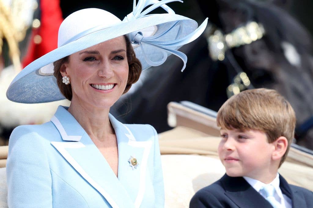 Princess Kate smiling in blue jacket and hat with son Louis
