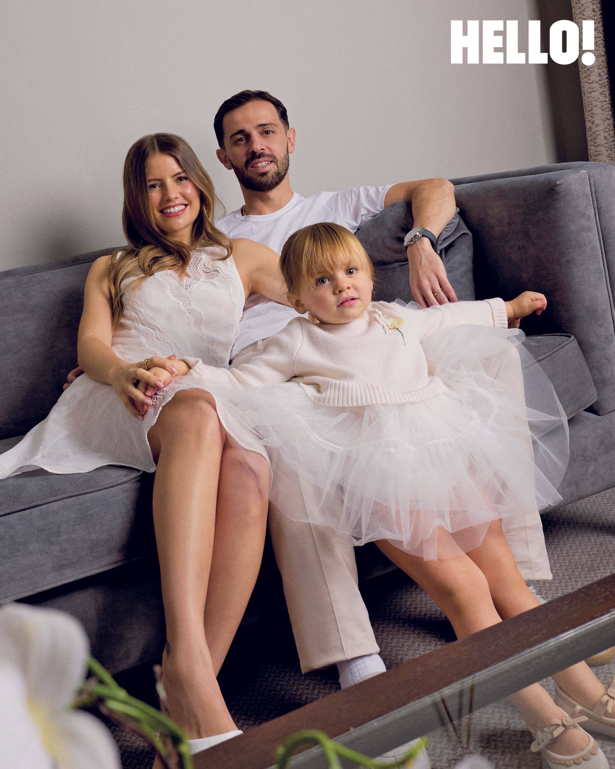 Inês and Bernardo Silva with their toddler Carlota, who is wearing a tulle skirt
