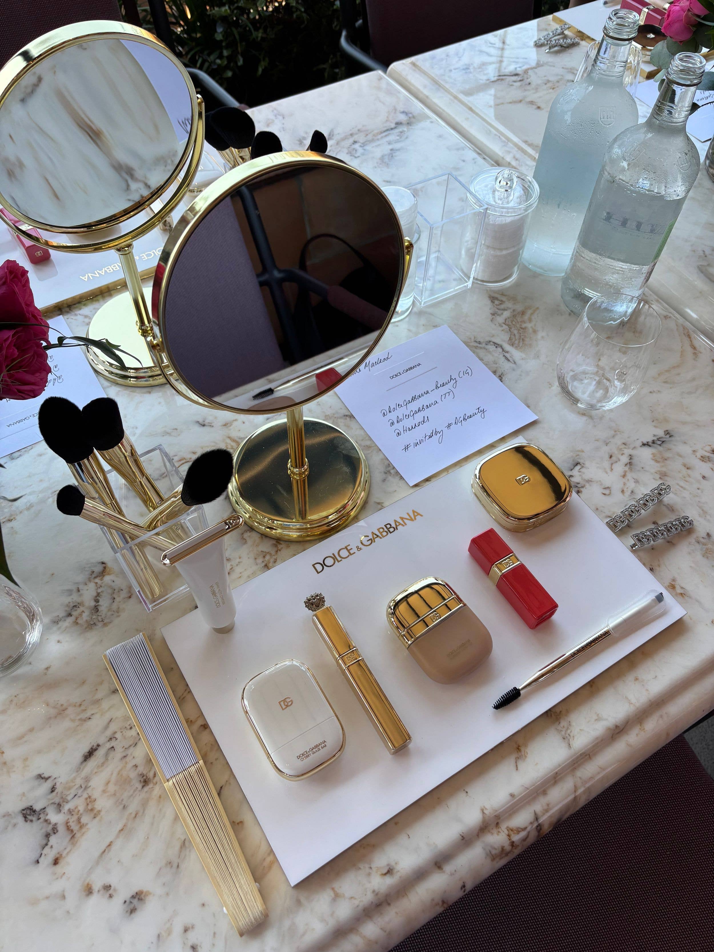 D&G makeup on a marble top with a mirror 