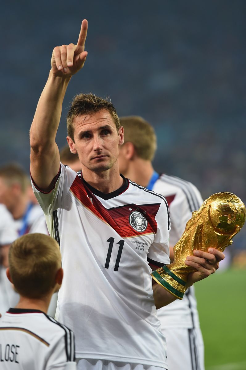 Miroslav Klose  of Germany celebrates with the World Cup trophy after defeating Argentina 1-0 in extra time during the 2014 FIFA World Cup