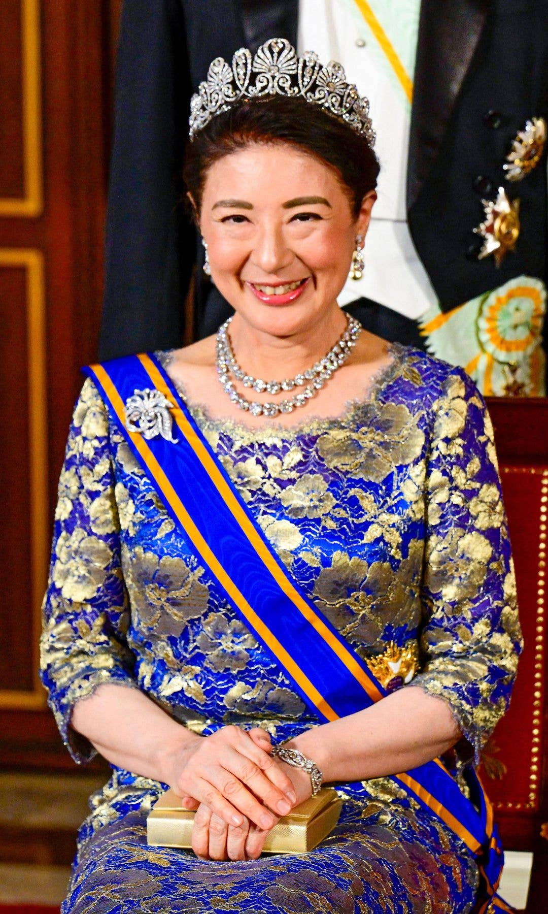 Empress Masako in a blue and gold gown with a tiara